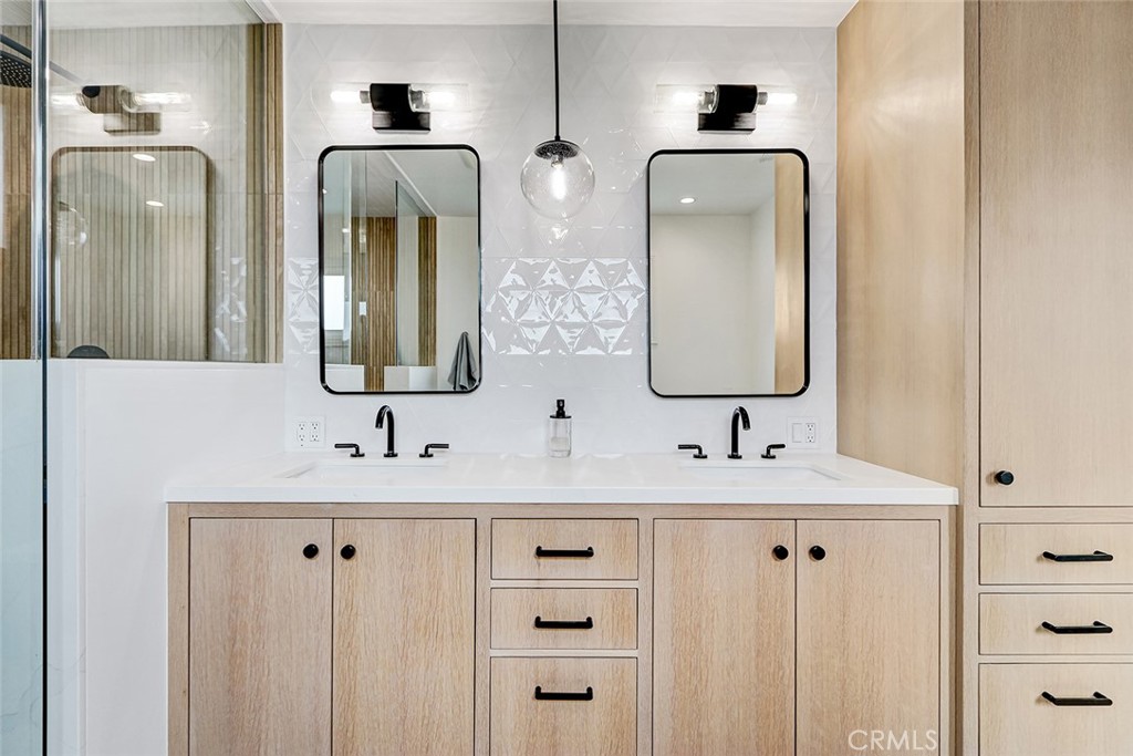 825 Center Street El Segundo, CA 90245 - Photo 27 of 52 a bathroom with double vanity sinks and a mirror