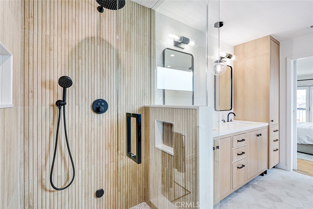 825 Center Street El Segundo, CA 90245 - Photo 28 of 52 a bathroom with a double vanity sink a shower and a mirror