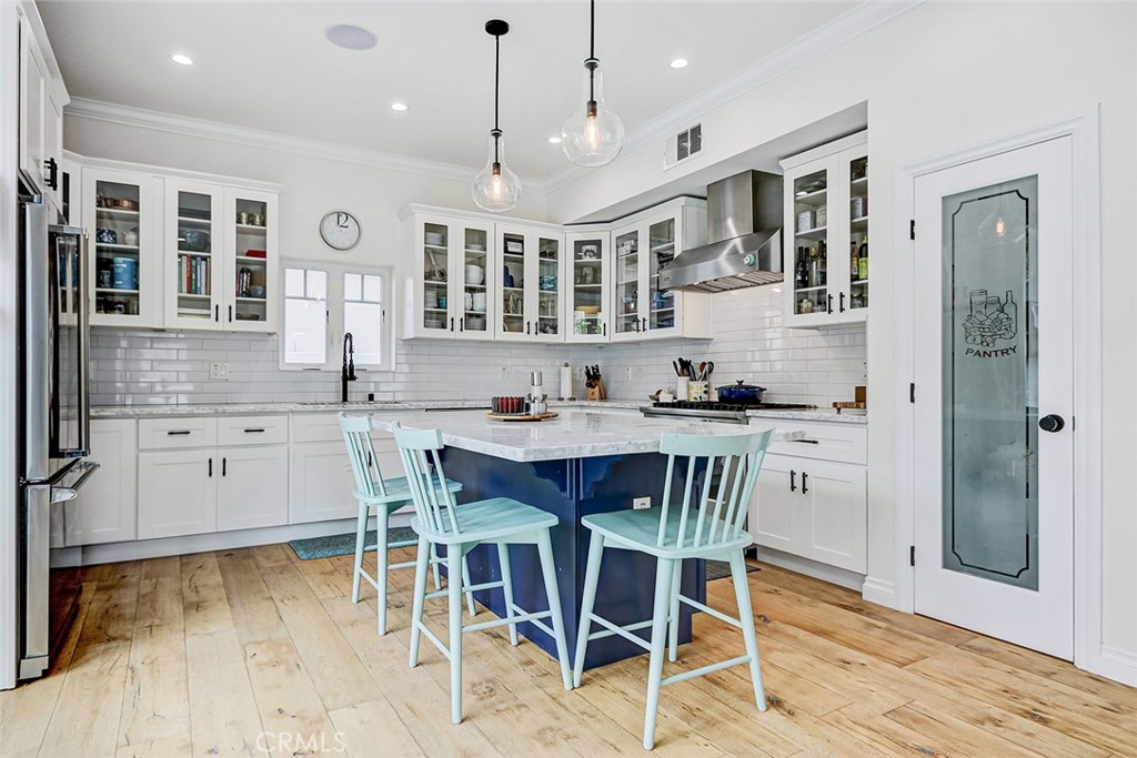 825 Center Street El Segundo, CA 90245 - Photo 5 of 52 a kitchen with stainless steel appliances granite countertop a stove a sink dishwasher a dining table and chairs with wooden floor