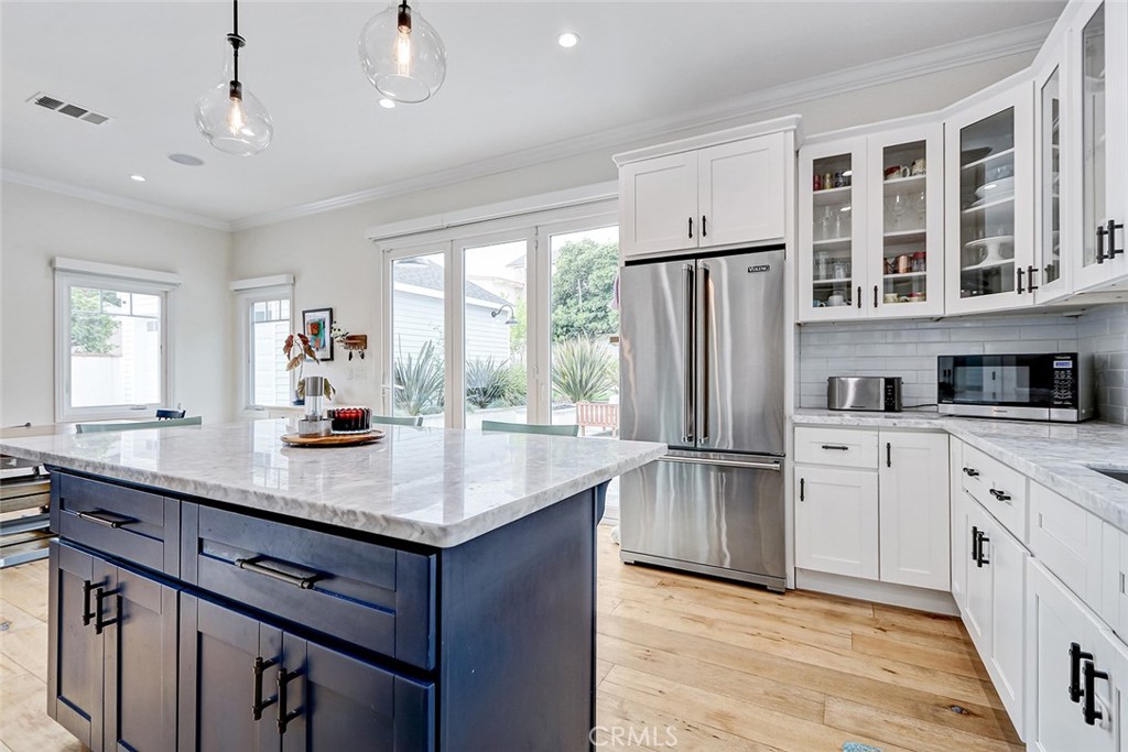 825 Center Street El Segundo, CA 90245 - Photo 6 of 52 a kitchen with stainless steel appliances granite countertop a refrigerator a sink dishwasher a stove and white countertops with wooden floor