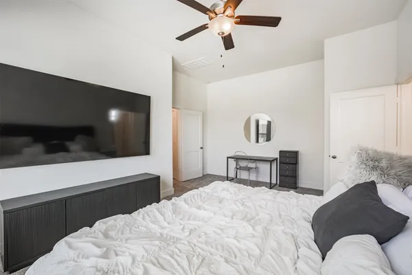 a bedroom with a bed and a television