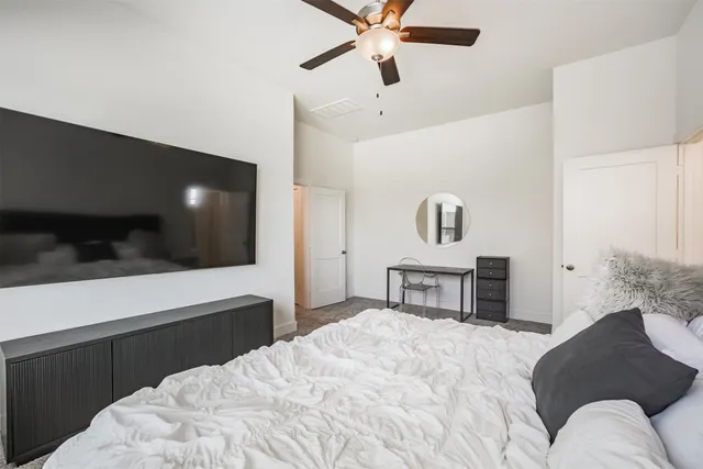 a bedroom with a bed and a television