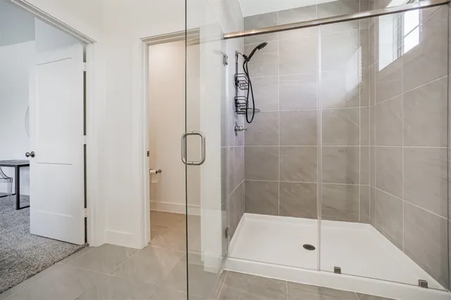 a bathroom with a shower and a bath tub