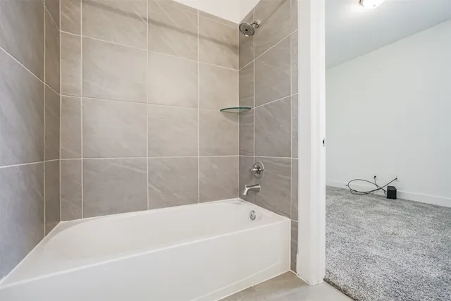 a bathroom with a tub and a shower