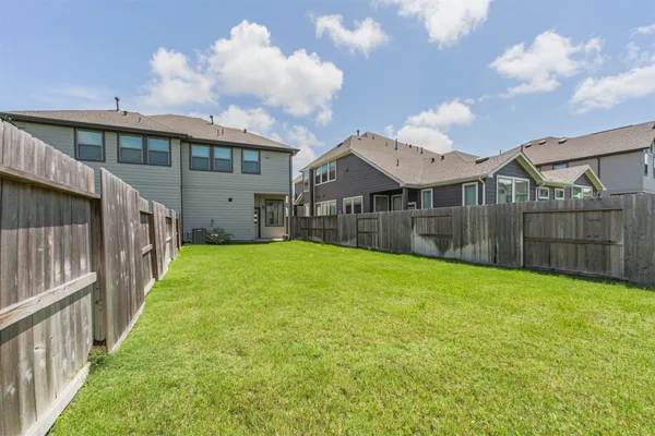 a view of a backyard with a garden and deck