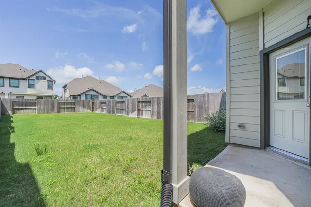 a view of a house with a porch and a yard