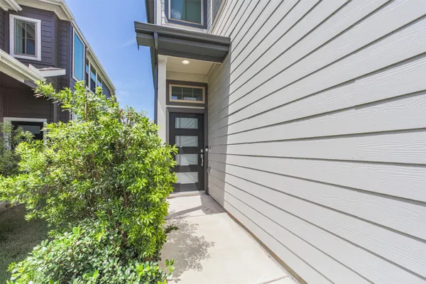 a view of small house with potted plants