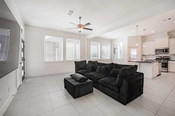 a living room with furniture and kitchen view