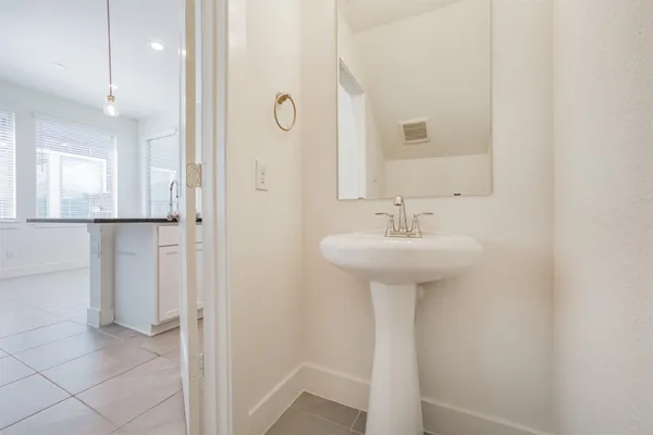 a bathroom with a sink a mirror and shower