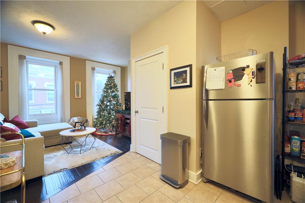 515 Lockhart Street, Unit 3 Pittsburgh, PA 15212 - Photo 11 of 27 a living room with furniture and a refrigerator