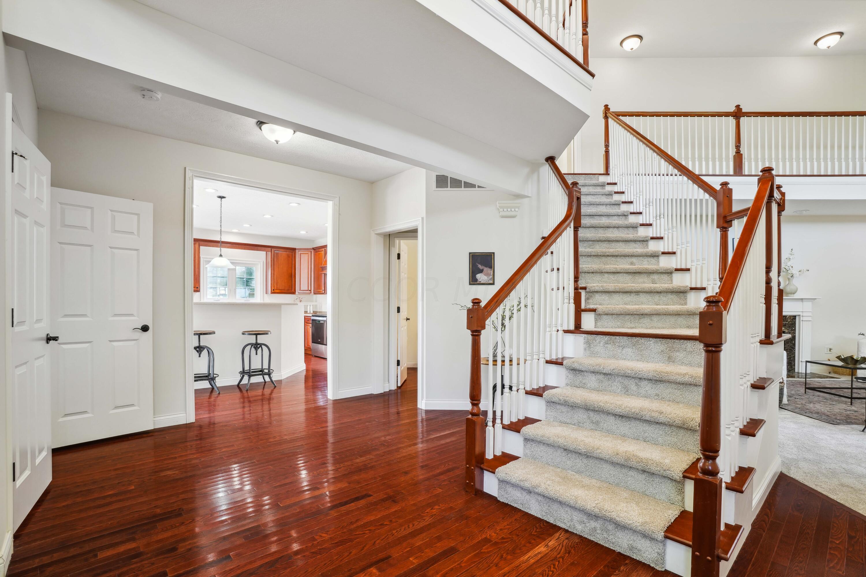 10403 Liberty Road Powell, OH 43065 - Photo 4 of 76 Grand entry way with hardwood floors, views of the pond and a open staircase!