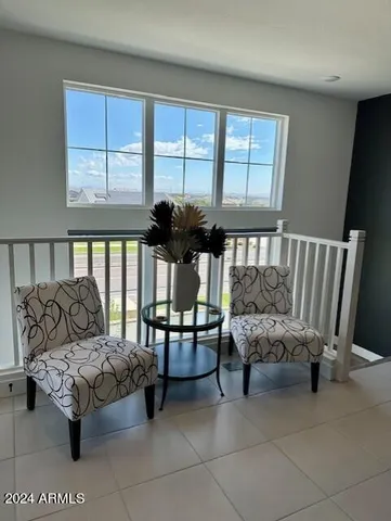 a bedroom with furniture and a large window