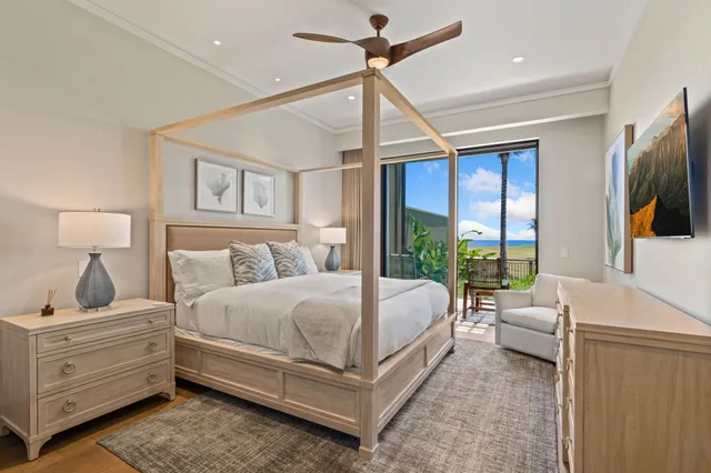 a bedroom with a large bed and a flat tv screen