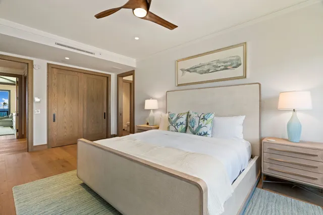 a bedroom with a bed and a painting on the wall