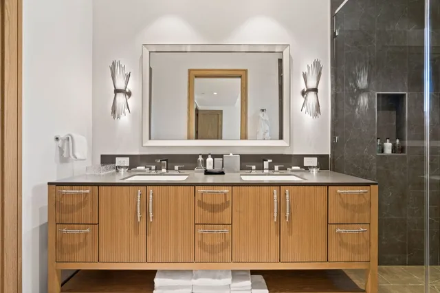 a bathroom with a sink a mirror and vanity