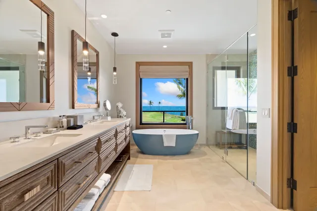 a bathroom with a double vanity sink a toilet a window and mirror