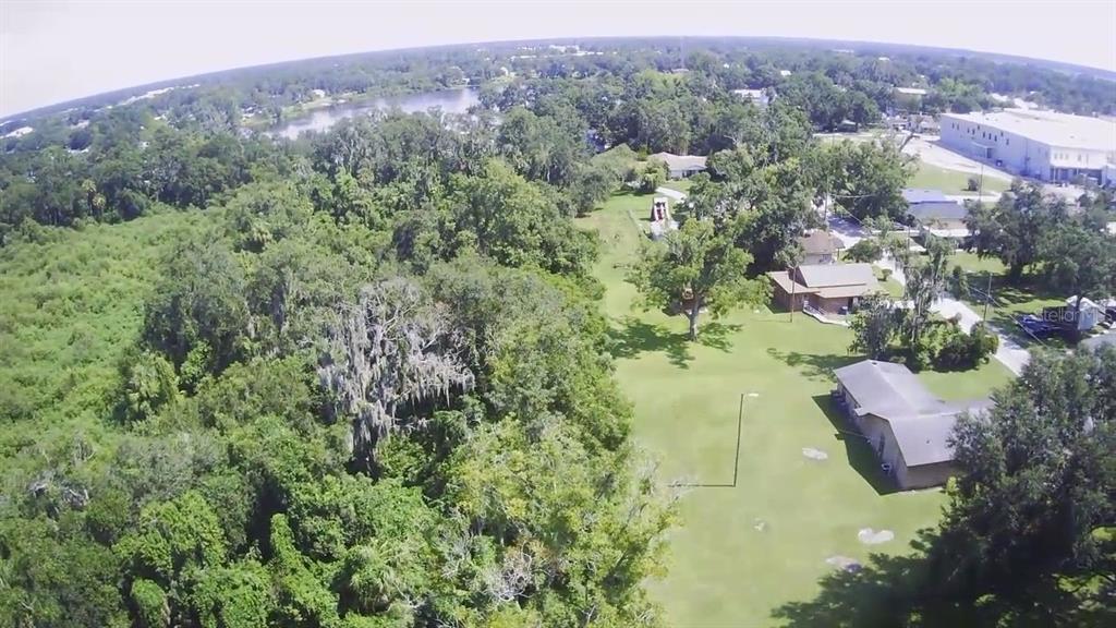 14913 Arrena Road Winter Garden, FL 34787 - Photo 2 of 8 an aerial view of a houses with a lush green hillside