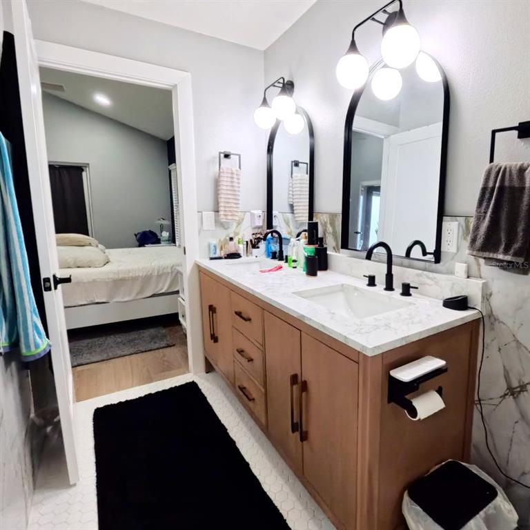 14913 Arrena Road Winter Garden, FL 34787 - Photo 8 of 8 a bathroom with double vanity and a mirror