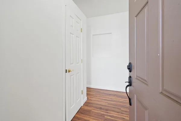 a view of a room with wooden floor
