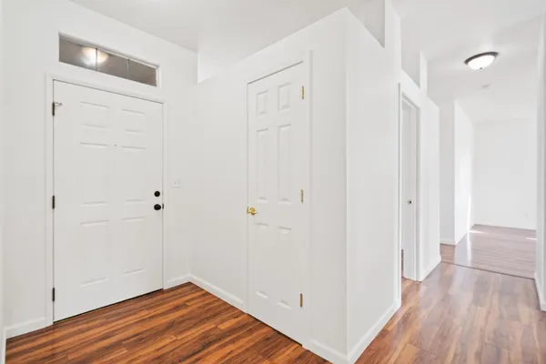 a view of a room with wooden floor