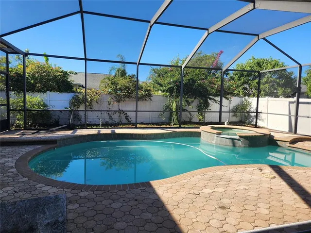 a view of a swimming pool with a patio