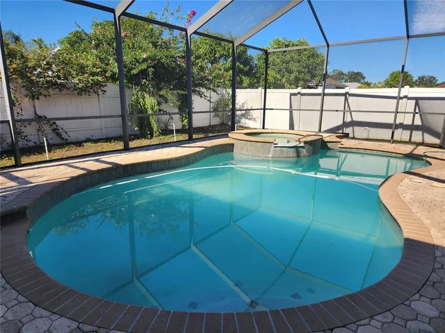 a view of a swimming pool with a yard