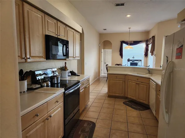 a kitchen with a sink cabinets and appliances