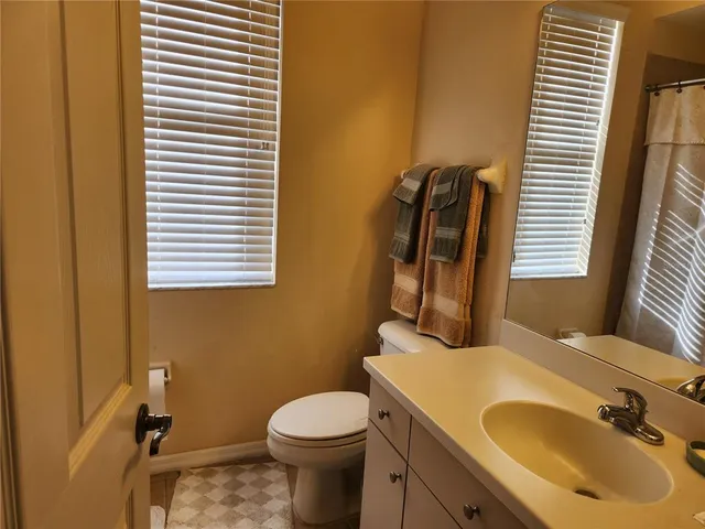 a bathroom with a sink toilet and mirror
