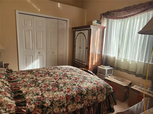 a bedroom with a bed and a mirror