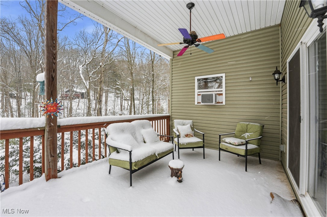 4254 Doral Road Southwest Carrollton, OH 44615 - Photo 14 of 46 Snow covered patio featuring a ceiling fan and a wooden deck