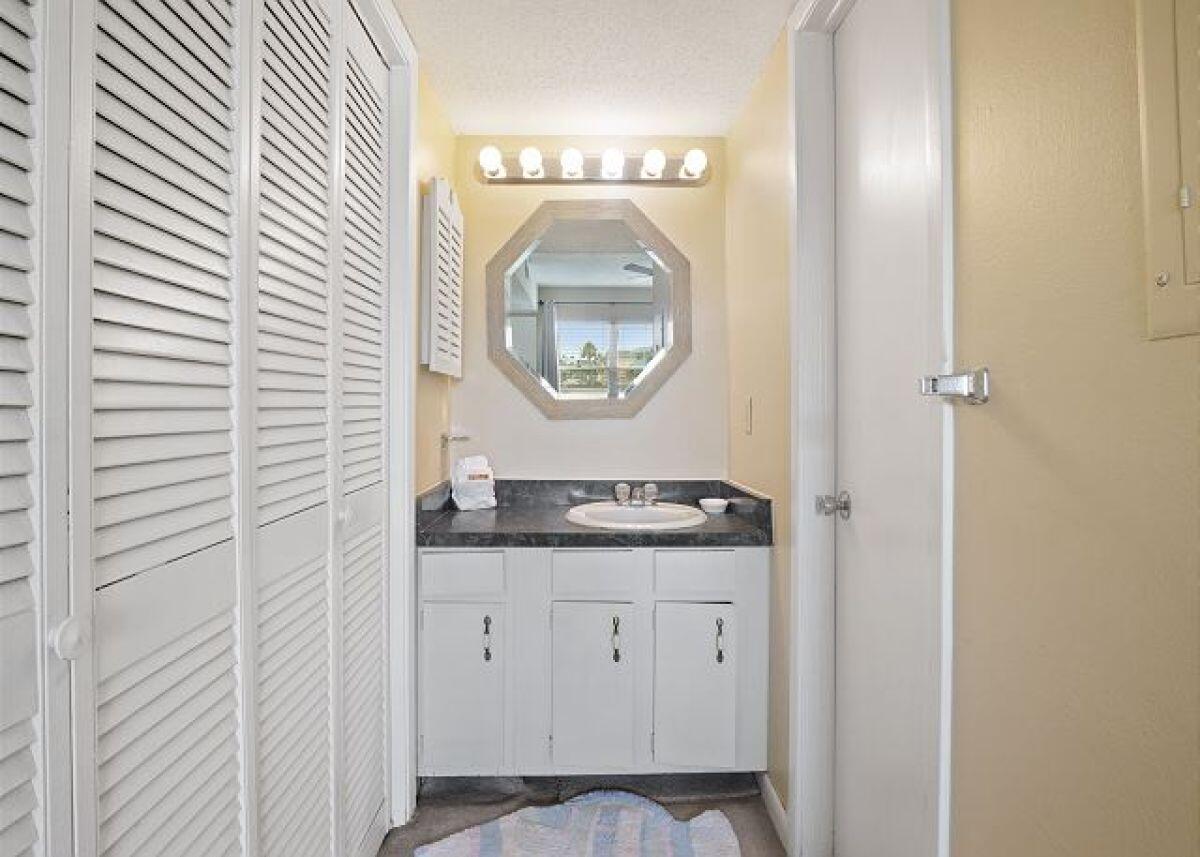909 Santa Rosa Boulevard, Unit 211 Fort Walton Beach, FL 32548 - Photo 11 of 21 a bathroom with a granite countertop sink and a mirror