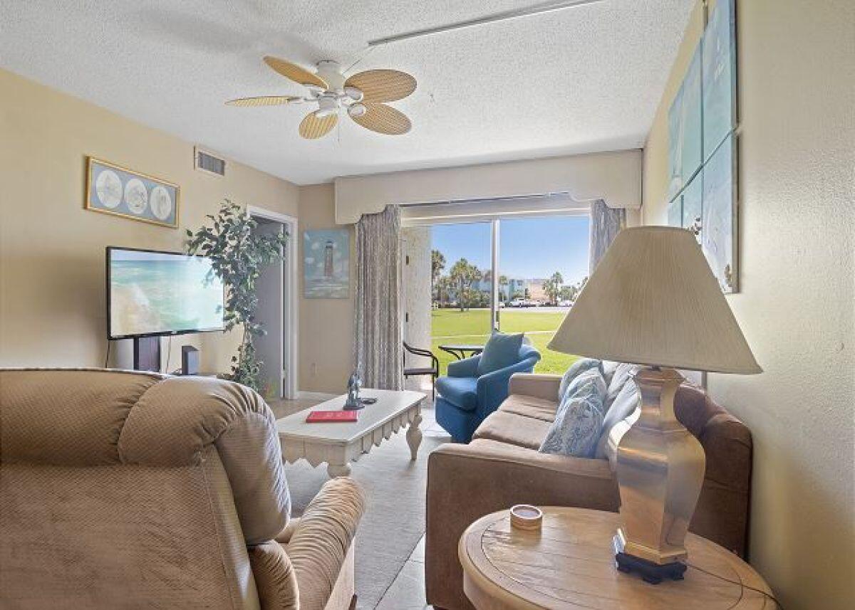 909 Santa Rosa Boulevard, Unit 211 Fort Walton Beach, FL 32548 - Photo 5 of 21 a living room with furniture and a large window