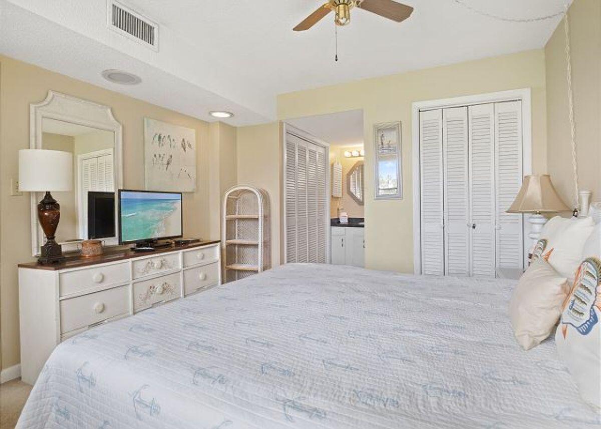 909 Santa Rosa Boulevard, Unit 211 Fort Walton Beach, FL 32548 - Photo 9 of 21 a large white bedroom with a large bed and a flat tv screen on dresser