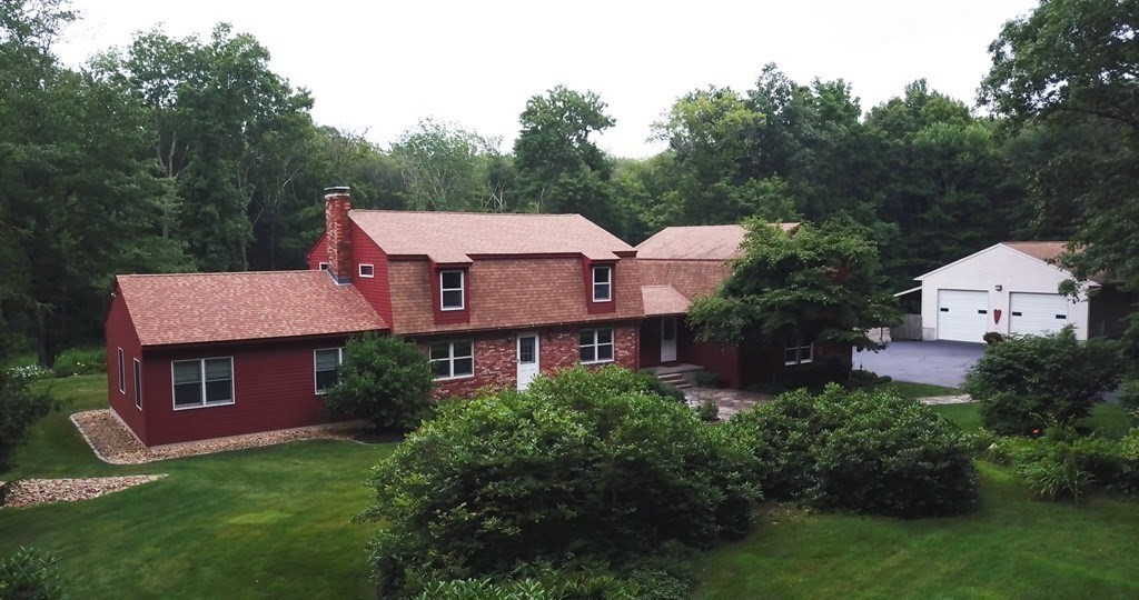 65 Purgatory Road Sutton, MA 01590 - Photo 1 of 40 a front view of a house with a garden