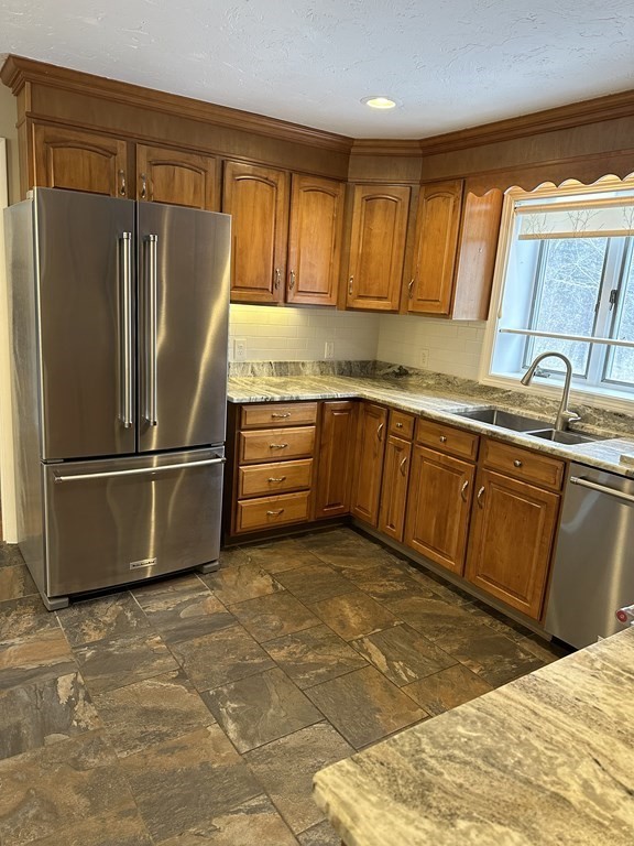 65 Purgatory Road Sutton, MA 01590 - Photo 13 of 40 a kitchen with stainless steel appliances granite countertop a refrigerator a sink dishwasher a stove with wooden cabinets and floor