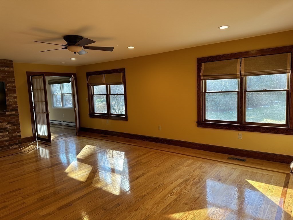 65 Purgatory Road Sutton, MA 01590 - Photo 17 of 40 a view of a livingroom with wooden floor and a window