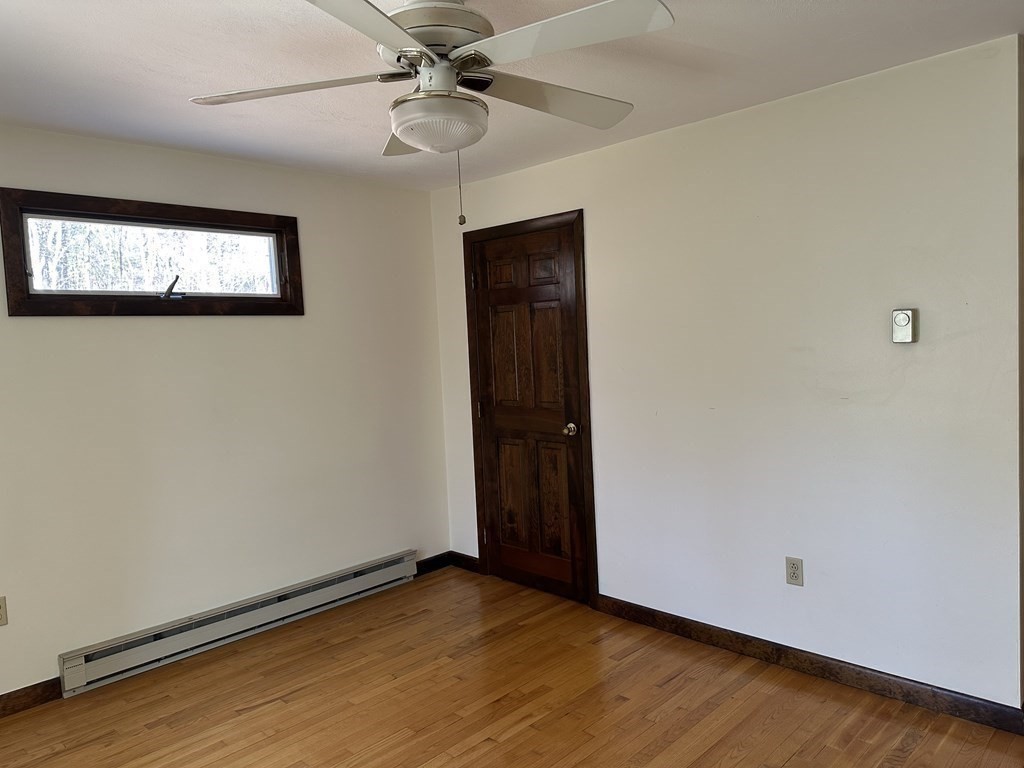 65 Purgatory Road Sutton, MA 01590 - Photo 28 of 40 a view of an empty room with window and wooden floor