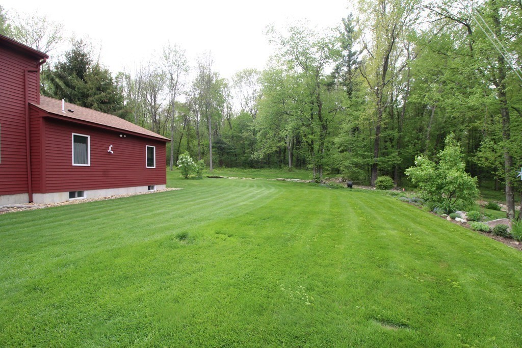 65 Purgatory Road Sutton, MA 01590 - Photo 5 of 40 a view of a yard with a house
