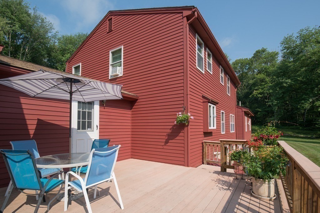 65 Purgatory Road Sutton, MA 01590 - Photo 6 of 40 a backyard of a house with wooden deck and furniture