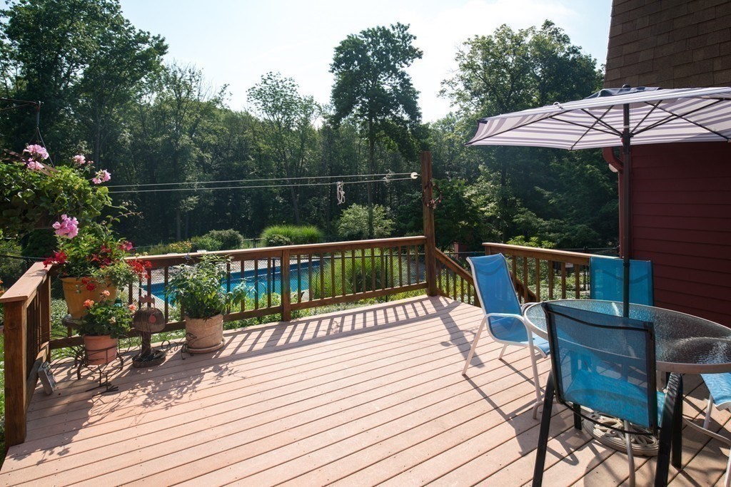 65 Purgatory Road Sutton, MA 01590 - Photo 7 of 40 a view of a chairs on wooden deck