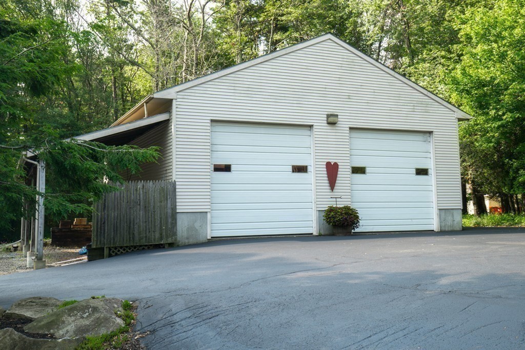 65 Purgatory Road Sutton, MA 01590 - Photo 10 of 40 a view of a house with a yard and garage