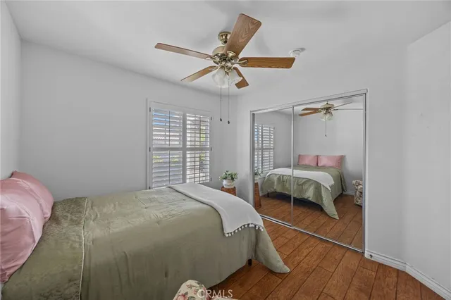 a bathroom with a granite countertop sink mirror vanity and toilet