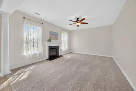 a view of livingroom with window fireplace and window