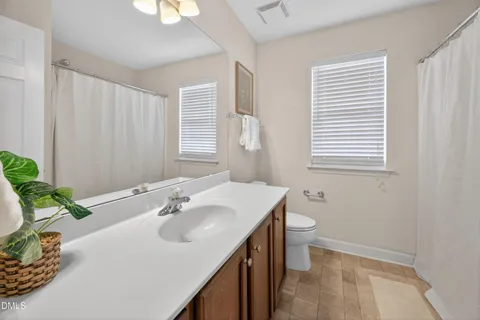 an empty room with chandelier fan