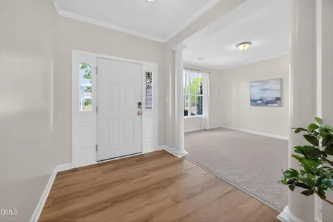 a view of a house with a yard and potted plants