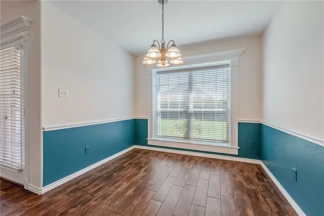 a view of wooden floor and windows in a room