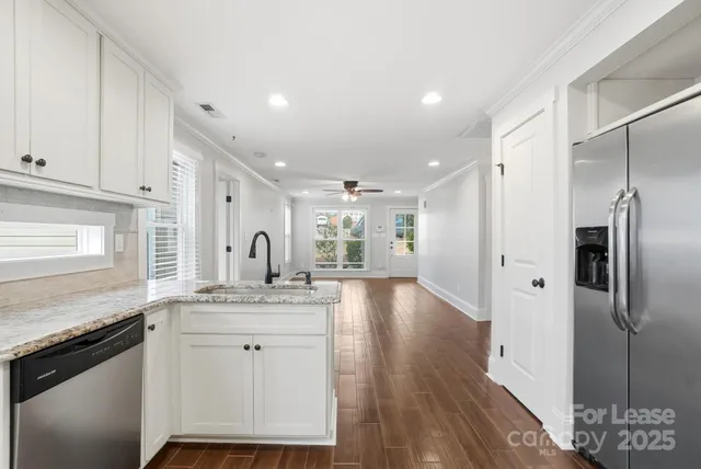 a kitchen with a sink refrigerator and cabinets