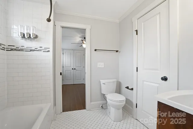 a bathroom with a toilet a sink and shower
