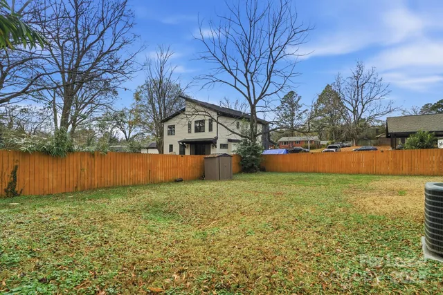 a view of a yard with a house in the background