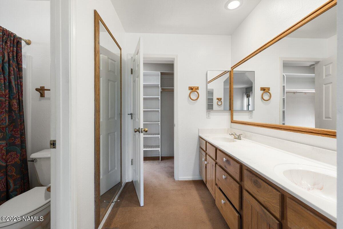 5535 East Western Star Road Flagstaff, AZ 86004 - Photo 26 of 49 a spacious bathroom with a granite countertop sink mirror and a